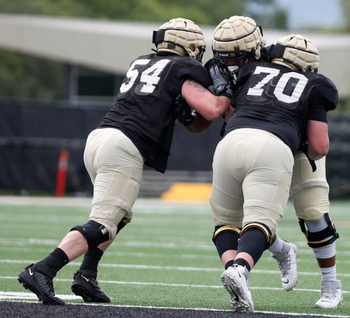 Purdue Boilermakers offensive lineman Josh Kaltenberger (54) and Purdue Boilermakers offensive lineman Zach Richards (70) block Purdue Boilermakers offensive lineman Sione Finau (72) during practice at Purdue University in West Lafayette, Ind.